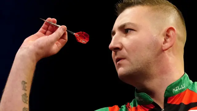 Nathan Aspinall throws a dart