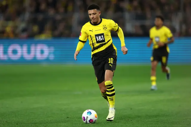 Jadon Sancho runs with the ball