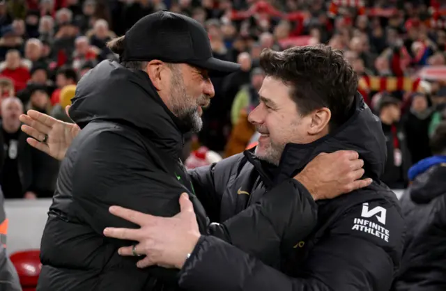 Jurgen Klopp and Mauricio Pochettino hug before the match at Anfield