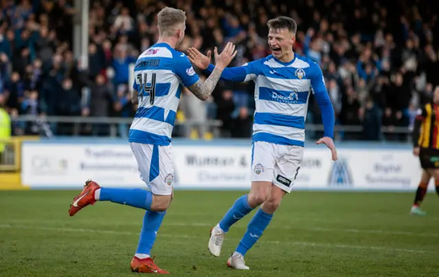 Morton's Robbie Crawford  celebrates with teammate Cameron Blues (R) after his shot comes off Jack McMillan (not in frame) and deflects into the net to make it 1-0 during a cinch Championship match between Greenock Morton and Partick Thistle at Cappielow Park