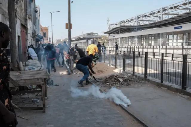 Protesters flee teargas in Dakar on 9 February.