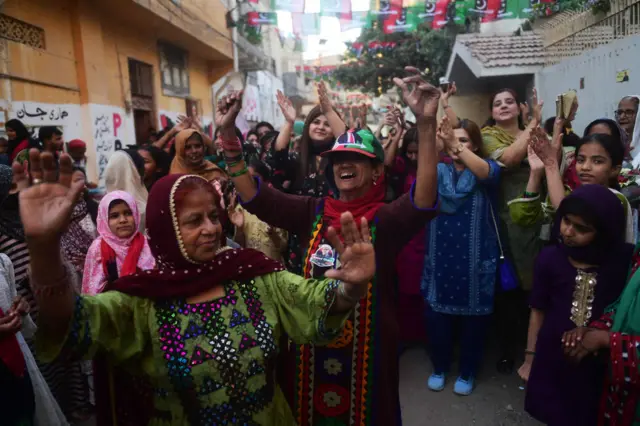 Pakistan Peoples Party (PPP) supporters celebrate the victory of a provincial assembly candidate in Karachi