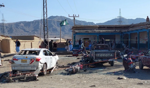 Destroyed cars and detritus from the blast outside an election campaign office in Pishin on 7 Feburary