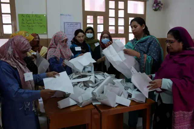 Polling staff count ballots after the voting ends in Hyderabad, Pakistan, 08 February 2024