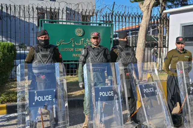 Police stand guard in front of the Election Commission office in Islamabad