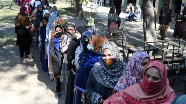 Women line up to cast their ballot at a polling station, during general elections in Lahore, Pakistan