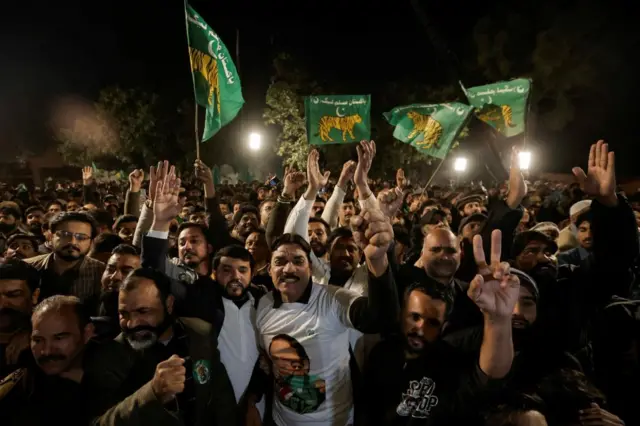 Supporters of Nawaz Sharif cheer as they gather at the party office of Pakistan Muslim League (N) at Model Town in Lahore