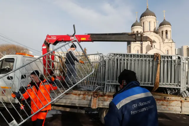 Moscow's municipal workers unload metal fences