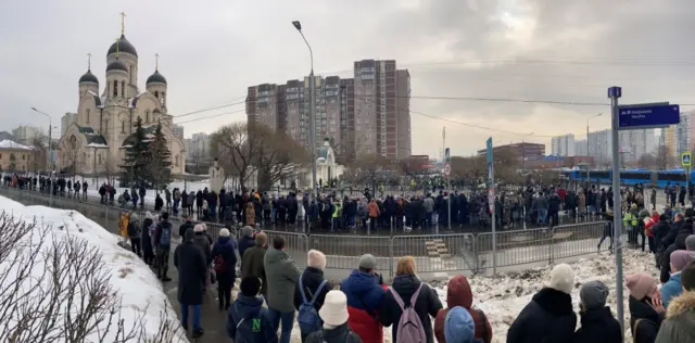 Mourners gather in front of the Mother of God Quench My Sorrows church