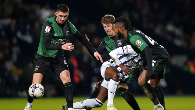 Coventry players grapple for the ball