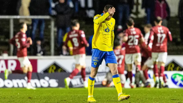 Raith's Sam Stanton looks dejected as Arbroath's Mark Stowe celebrates after he scores to make it 3-2 during a cinch Championship match between Arbroath and Raith Rovers at Gayfield Park, on March 01, 2024, in Arbroath, Scotland.