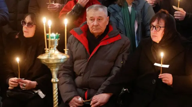 Alexey Navalny's parents, Anatoliy (centre) and Lyudmila (right), during his funeral service