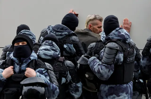 Russian police detain a man near Borisovskoye cemetery in Moscow