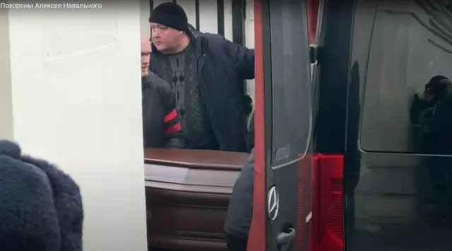 People seen carrying what is believed to be Alexei Navalny's coffin