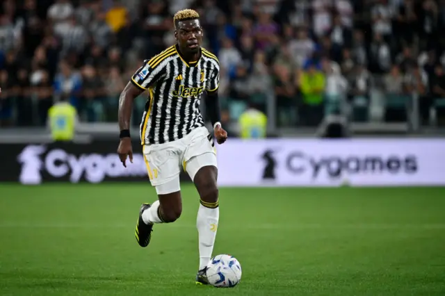 Paul Pogba runs with the ball