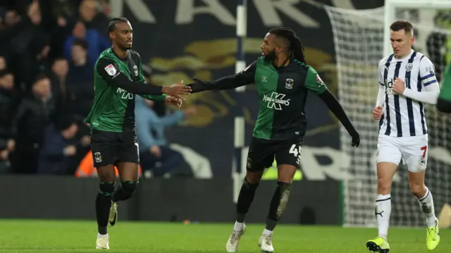 Haji Wright (left) clasps hands with Kasey Palmer after scoring a penalty