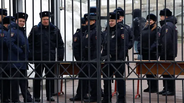 Police officers stand guard near the church