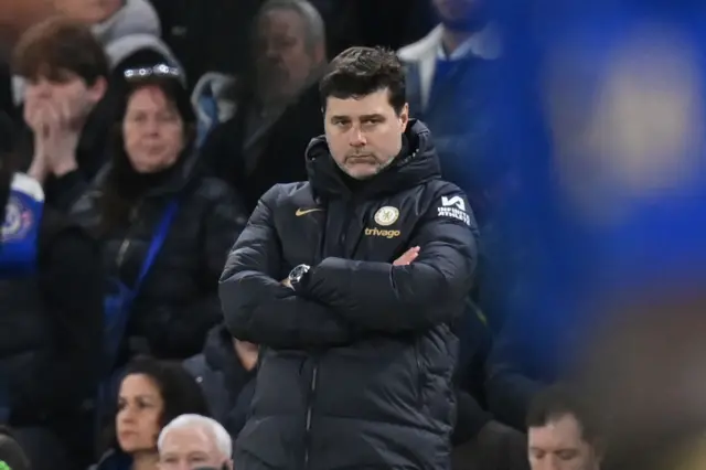 Mauricio Pochettino stands with his arms folded