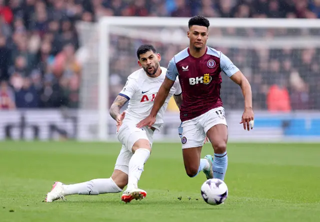 Ollie Watkins of Aston Villa is challenged by Cristian Romero