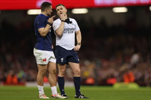 Referee Luke Pearce in discussion with France captain