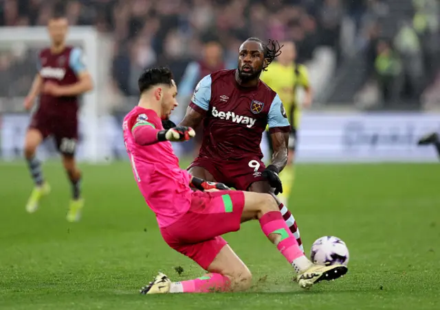 Michail Antonio of West Ham United is challenged by James Trafford