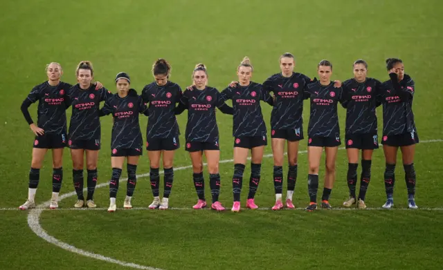 City players stand on the halfway line ahead of the shootout.