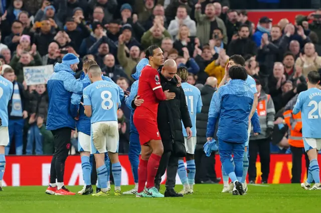 Pep Guardiola and Virgil van Dijk embrace each other