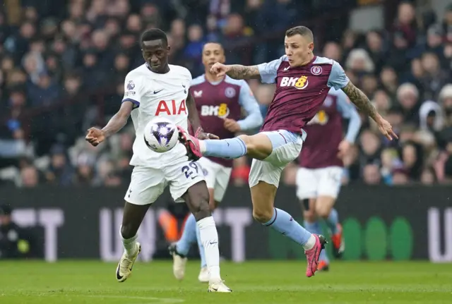 Pape Matar Sarr (left) and Aston Villa's Lucas Digne battle for the ball