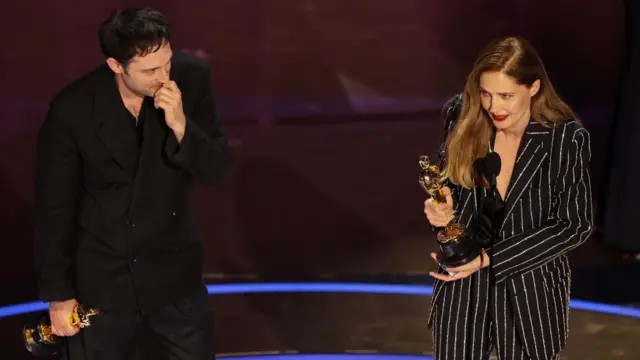 Justine Triet and Arthur Harari win the Oscar for Best Original Screenplay for "Anatomy of a Fall" during the Oscars show at the 96th Academy Awards in Hollywood, Los Angeles, California, U.S., March 10, 2024.