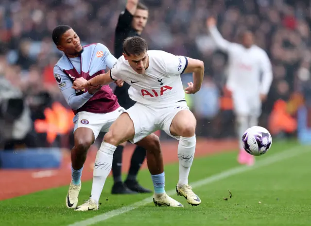 Leon Bailey in action with Tottenham Hotspur's Micky van de Ven