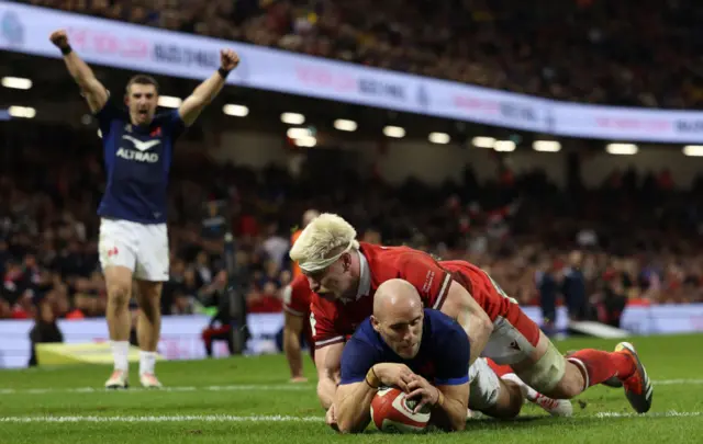 France's Maxime Lucu dives over the line to score