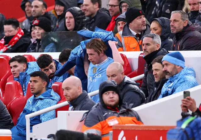 Kevin de Bruyne sits on the bench