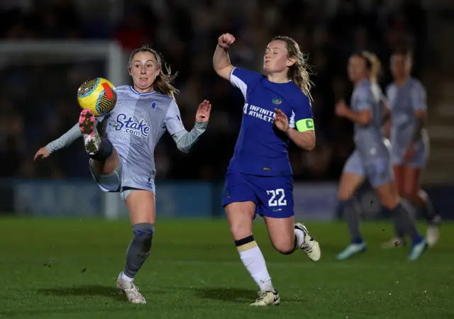 Wheeler looks to juggle the ball away from Cuthbert in midfield.