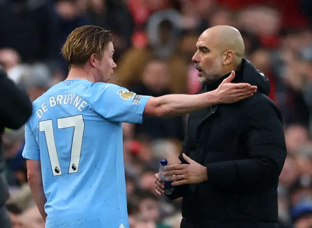 Kevin De Bruyne reacts with manager Pep Guardiola