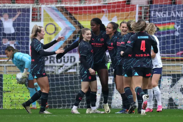 City players celebrate with Fowler after her opening goal.