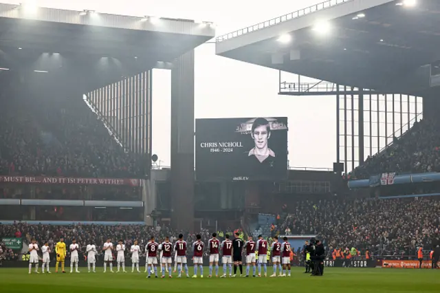 Players respect a minute silence for  Chris Nicholl