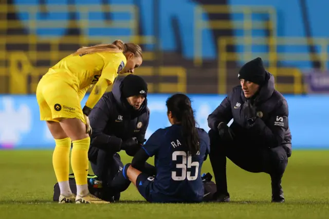 Mayra Ramirez receives treatment as Hannah Hampton is on hand to translate.