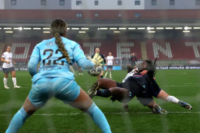 Bunny Shaw goes down in the box as Spencer looks on from her goal.