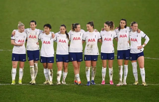 Spurs players stand on the halfway line ahead of the shootout.