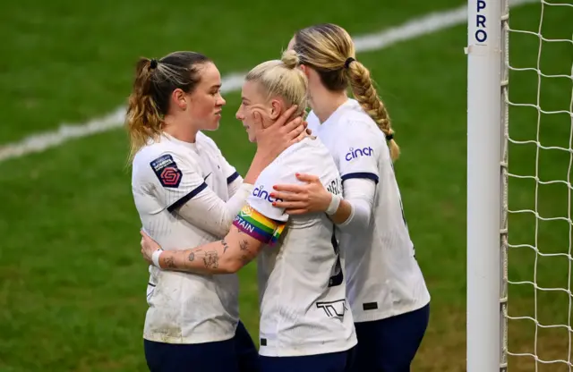 Spurs players congratulate England for her goal.