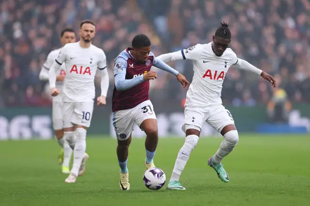 Leon Bailey of Aston Villa is challenged by Yves Bissouma