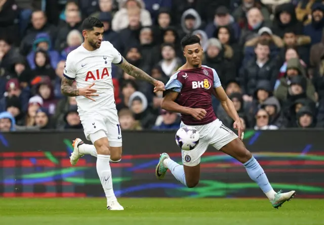 Cristian Romero (left) and Aston Villa's Ollie Watkins battle for the ball