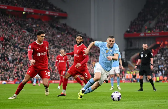 Mateo Kovacic of Manchester City breaks with the ball past Jarell Quansah