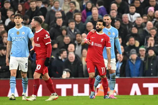 Mohamed Salah of Liverpool reacts alongside Kyle Walker