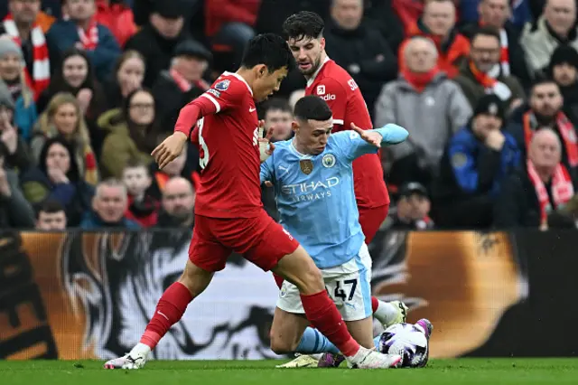 Phil Foden vies with Liverpool's Japanese midfielder Wataru Endo