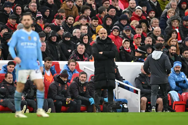 Pep Guardiola, Manager of Manchester City, looks on