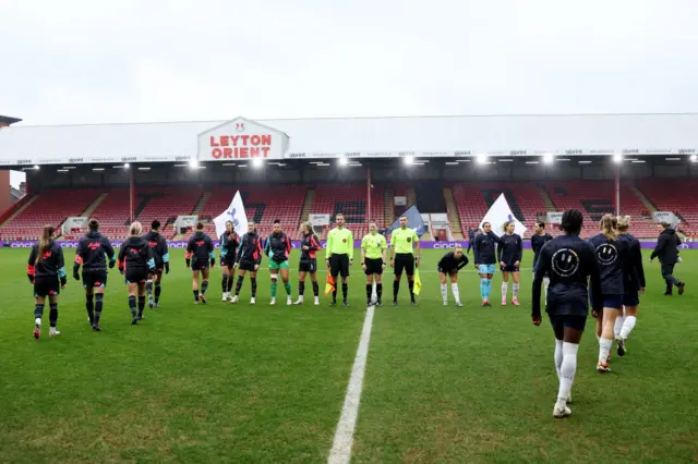 Spurs and City players make their way out onto the pitch.