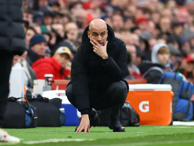 Pep Guardiola looks on