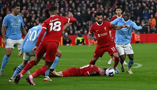 0 Alexis Mac Allister lays on the pitch after a challenge from Jeremy Doku