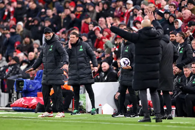 Jurgen Klopp, Manager of Liverpool (L) reacts on the touchline alongside Pep Guardiola